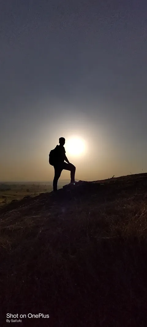 Silhouette on a hilltop at sunset